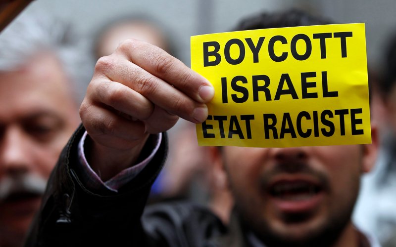 A demonstrator displays a sign reading "Boycott Israel, racist state" outside the Belgian foreign affairs building during a protest in Brussels, May 31, 2010. Picture by Francois Lenoir | Reuters