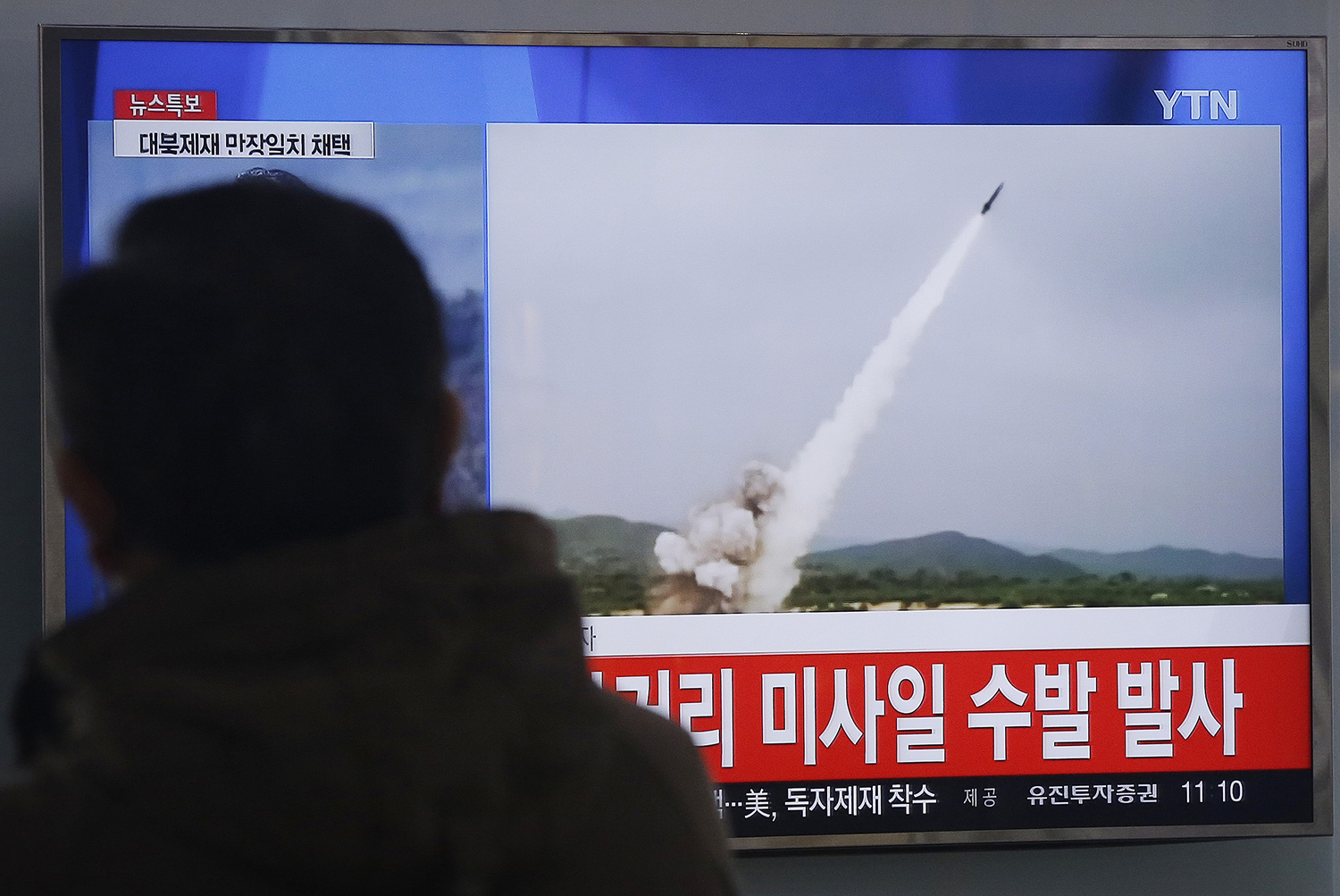 A man watches a TV news program showing a file footage of the missile launch conducted by North Korea, at Seoul Railway Station in Seoul, South Korea, Thursday, March 3, 2016. North Korea fired several short-range projectiles into the sea off its east coast Thursday, Seoul officials said, just hours after the U.N. Security Council approved the toughest sanctions on Pyongyang in two decades for its recent nuclear test and long-range rocket launch. The screen reads " North Korea launched missiles." Picture by Ahn Young-joon | AP