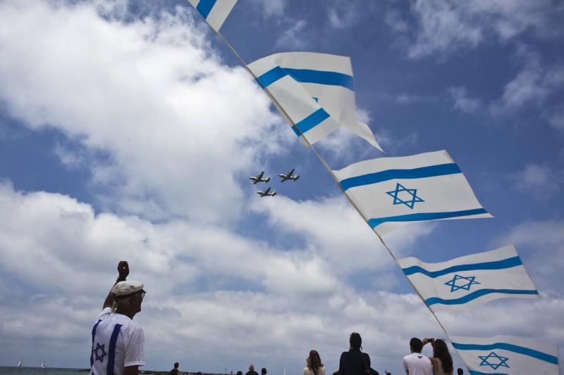 Israelis look on as Israeli air force jets fly in formation over the Mediterranean Sea during celebrations for Israel's Independence Day. Picture by Nir Elias | Reuters