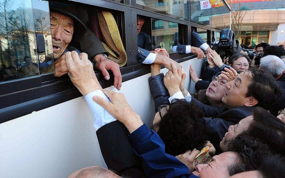 North Koreans on a bus and their South Korean relatives, separated since the Korean War, bid farewell after a brief family reunion. Picture by Kim Ho-Young-Korea | Pool | Getty Images