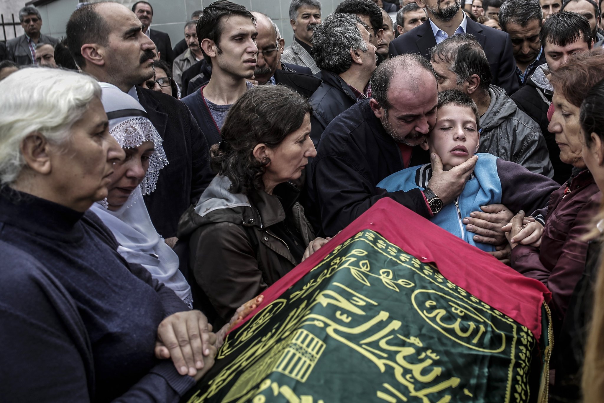 Relatives comfort nine-year-old Cayan Tuylu near the casket of his father Sarigul, a victim of the twin bombings in Ankara the day before, at his funeral in Istanbul on Sunday. Picture by Yasin Akgul | Agence France-Presse/Getty Images