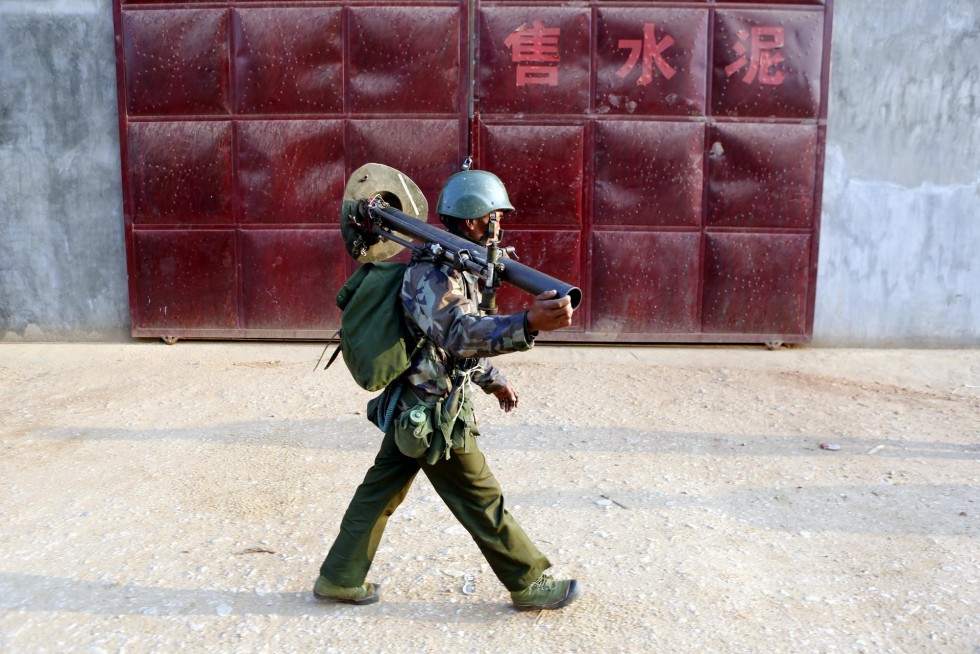 A Myanmese soldier carries a mortar in northeastern Shan state as he prepares for battle. Picture by Lynn Bo Bo | EPA