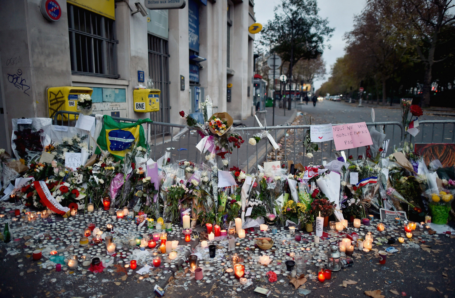 Flowers, candles and messages on Sunday near the Bataclan concert hall in Paris, where at least 89 people were killed. Picture by Jeff J Mitchell | Getty Images