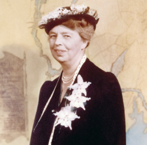 Photograph of Eleanor Roosevelt in a black dress with white accessories and white hat on yellow background.